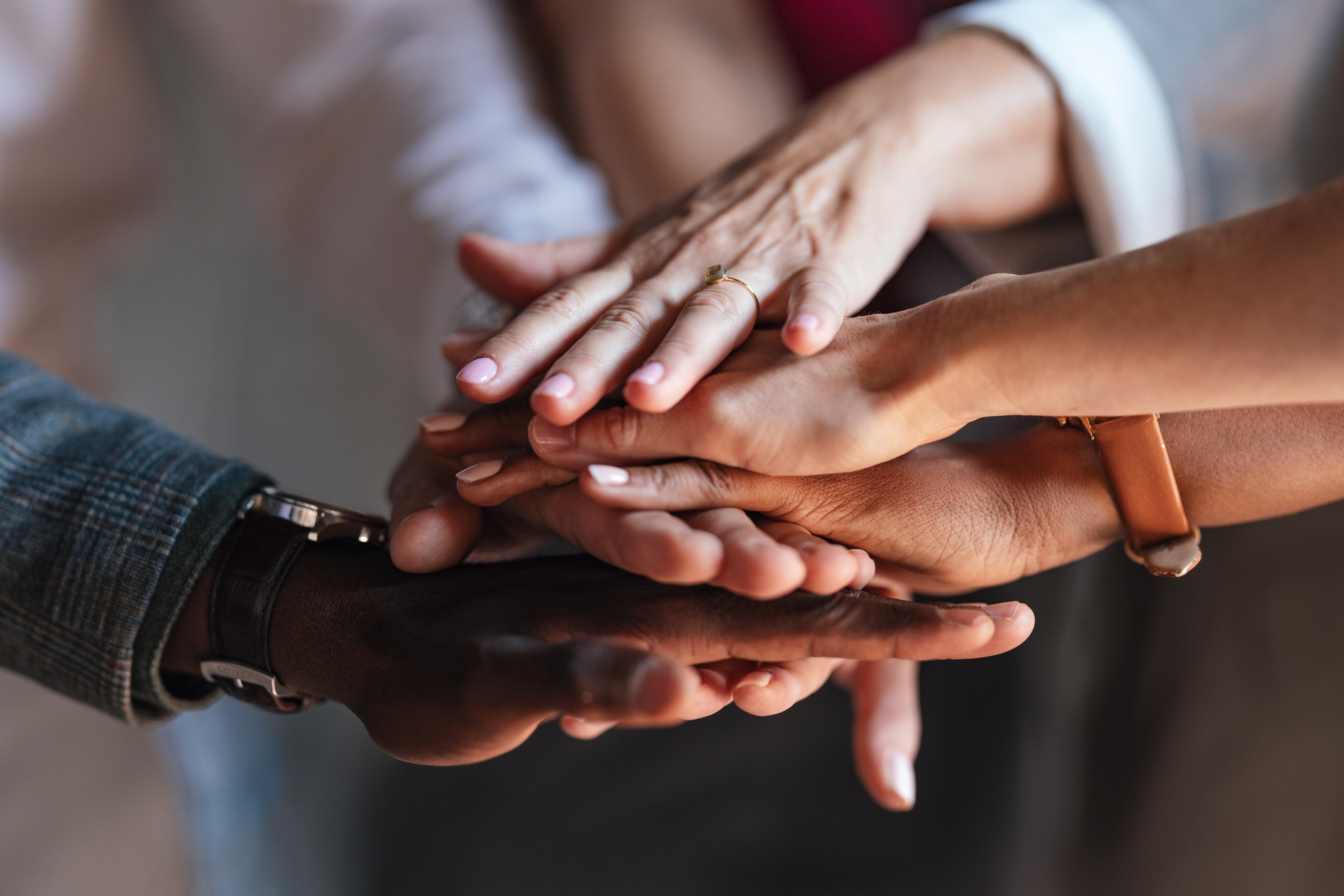 A close-up image of diverse hands stacked together, symbolizing collaboration for the Thrive Plus fixed indexed annuity product launch of The Standard and Ignite Partners.